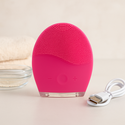 Ultrasonic Facial Cleansing Brush in pink with USB charging cable for smooth, youthful skin.